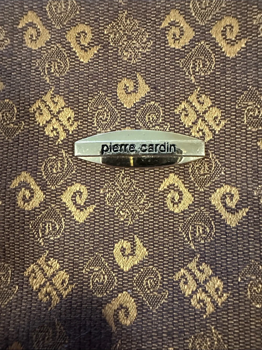 This is a brown Pierre Cardin monogram logo tote bag with beige leather handles.
